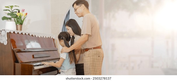  Portrait of enjoy happy love Asian family mother, father, son and daughter, smiling and having fun teaching and play piano music lesson at home. Family, keyboard piano and playing music. - Powered by Shutterstock