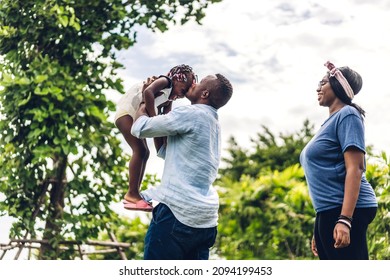 Portrait Of Enjoy Happy Love Black Family African American Father And Mother With Little African Girl Child Smiling And Play Having Fun Moments Good Time In Summer Park At Home