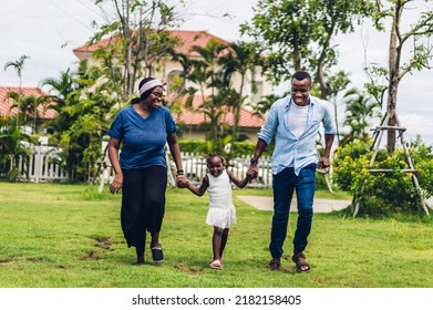 Portrait Of Enjoy Happy Love Black Family African American Father And Mother With Little African Girl Child Smiling And Play Having Fun Moments Good Time In Park At Home