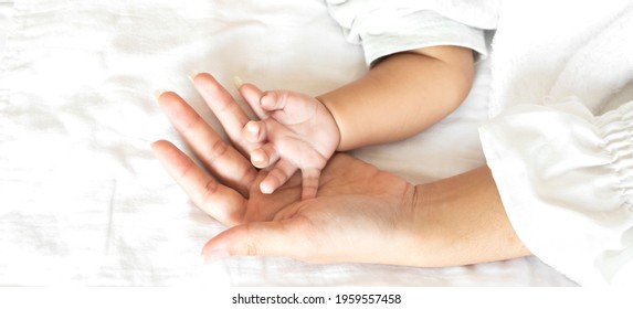 Portrait Of Enjoy Happy Love Family Asian Mother Playing With Adorable Little Asian Baby.Mom Touching With Cute Son Moments Good Time In A White Bedroom.Love Of Family Concept