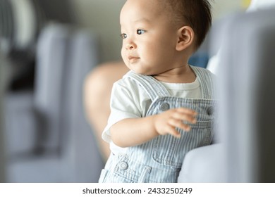 Portrait of enjoy happy love family asian mother playing with adorable little asian baby newborn infant, Mom touching care with cute son in a white bedroom.Love of family concept - Powered by Shutterstock