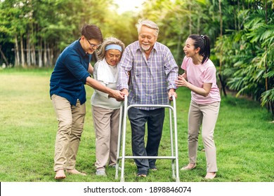 Portrait Enjoy Happy Smiling Love Multi-generation Asian Big Family.Senior Mature Father And Elderly Mother With Young Adult Woman And Son Walking Outdoor In Park At Home.insurance Concept