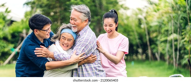 Portrait Enjoy Happy Smiling Love Multi-generation Asian Big Hug Family.Senior Mature Father And Elderly Mother With Young Adult Woman And Son Outdoor In Park At Home.insurance Concept