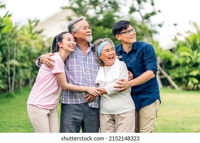 Portrait Enjoy Happy Smiling Love Multi-generation Asian Big Hug Family.Senior Mature Father And Elderly Mother With Young Adult Woman And Son Outdoor In Park At Home.insurance Concept