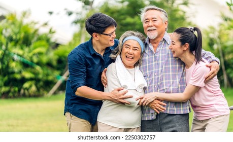 Portrait enjoy happy smiling love multi-generation asian big hug family.Senior mature father and elderly mother with young adult woman and son outdoor in park at home.insurance concept - Powered by Shutterstock