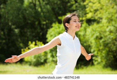 Portrait of enjoying woman raising her hands