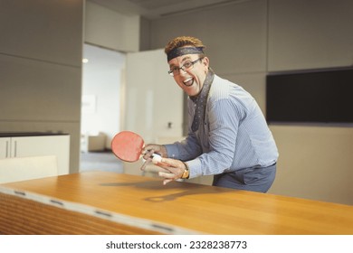 Portrait enthusiastic businessman playing ping pong tie wrapped around head in conference room