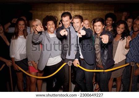 Portrait of enthusiastic crowd waiting in queue outside night club