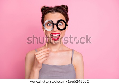 Portrait of enthusiastic funky girl have theme party hold eyeglasses mask imagine she nerd geek scream shout rejoice facial expression wear casual clothing isolated pink color background