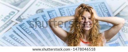 Portrait of an enthusiastic young girl screaming with joy against a background with dollars.