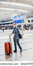  Portrait Of European Nerd Man In Glasses And Plaid Shirt With Luggage. Tourist Boarding Plane Taking A Flight Close To The Gate Wearing Face Mask. Coronavirus Flu Virus Travel 
