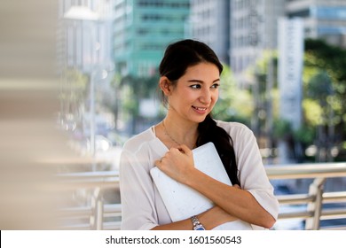 Portrait Of A European Woman Her Face Smiled Happily. She Held In The Outdoor City.Not Looking At The Camera