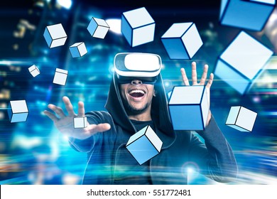 Portrait Of An Excited African American Man In Virtual Reality Glasses Playing A Game With Floating Cubes. Toned Image. Double Exposure