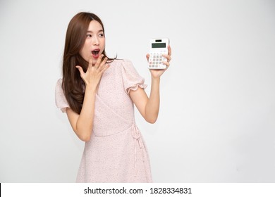 Portrait Of Excited Asian Woman Holding Calculator Isolated On White Background, Wow And Surprised Concept