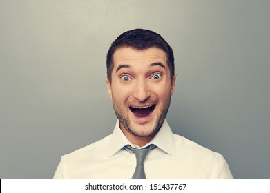 portrait of excited businessman over grey background - Shutterstock ID 151437767