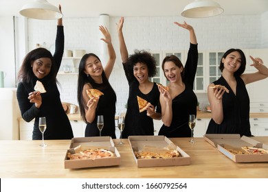 Portrait Excited Diverse Girls Holding Pizza Pieces, Celebrating Birthday Or Wedding At Hen Party, Five Beautiful Young Women Wearing Elegant Black Dresses Having Fun, Sharing Fast Food In Kitchen
