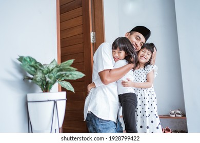 portrait of excited father hug and embrace his children during eid mubarak celebration together - Powered by Shutterstock