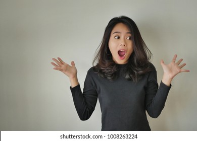 Portrait Of Excited Girl, Surprised Woman With Wow Oh Uh Ah Face Expression; Excited Woman, Happy Woman, Surprised Girl, Amazed Girl Portrait; Joyful Cheerful Person Asian Girl Young Adult Woman Model