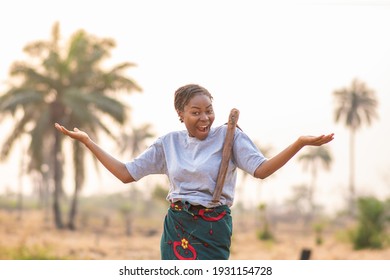 portrait of an excited and happy female african farmer