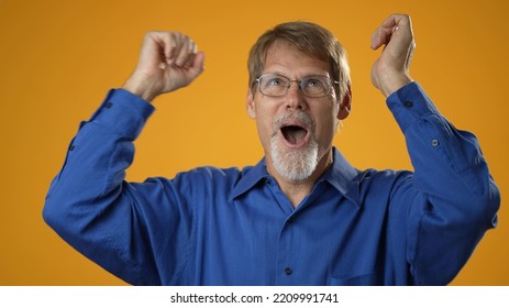 Portrait Of Excited Jubilant Overjoyed Elderly Bearded Man 50s 60s Doing Winner Gesture Celebrate Clenching Fists Say Yes Isolated On Solid Yellow Background Studio