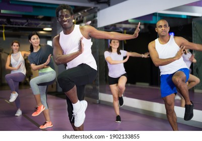 Portrait Of Excited Man Dancing During Group Class In Dance Center