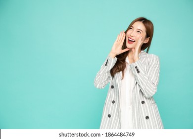 Portrait of excited screaming young asian woman isolated over green background, Wow and surprised concept
