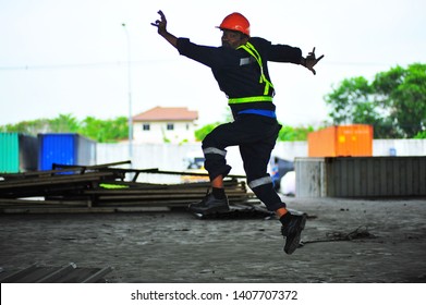 Portrait of an excited senior worker jumping while celebrating success over construction site background. - Powered by Shutterstock