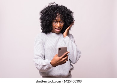 Portrait Of An Excited Young African Woman Look At Screen Mobile Phone Isolated Over White Background