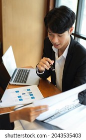 Portrait Of An Executive Board Member Reviewing Documents In A Document Folder