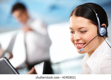 Portrait of executive female in headset smiling during communication - Shutterstock ID 41903011