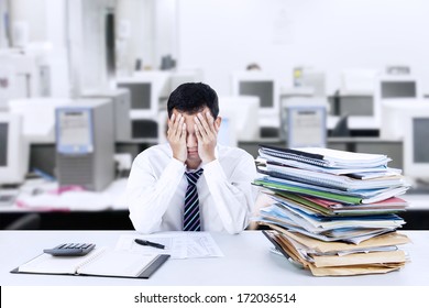 Portrait of exhausted businessman because overworked - Powered by Shutterstock