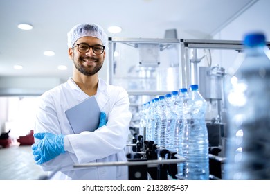 Portrait of an experienced caucasian technologist working in bottling factory producing drinking water. - Powered by Shutterstock