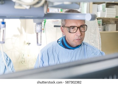 Portrait of an experienced doctor while performing heart catheterisation 