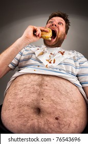 Portrait of expressive fat man eating burger
