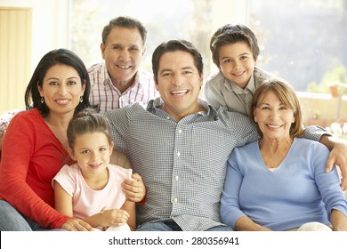 Portrait Of Extended Hispanic Family Relaxing At Home