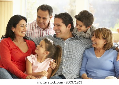 Portrait Of Extended Hispanic Family Relaxing At Home