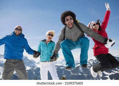 Portrait of exuberant friends in snow - Shutterstock ID 2109375605