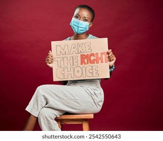 Portrait, face mask and poster with black woman in studio for protest, human rights activist and healthcare choice. Freedom of speech, safety and mpox virus with person and sign on red background - Powered by Shutterstock