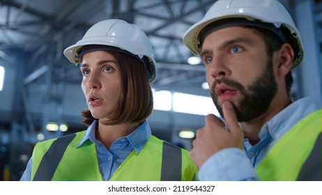 Portrait Factory Supervisors Discussing Supply Production Shipment Process. Two Green Reflective Uniformed Warehouse Employees Talking About Distribution Checking Tablet. Job Partnership Concept