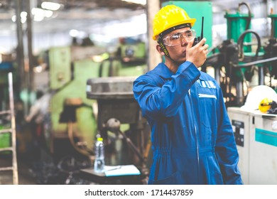 Portrait Of Factory Worker And Engineer At Industrial Facility. Construction Worker In Hardhat And Walkie-talkie Or Two Way Radio In Hand