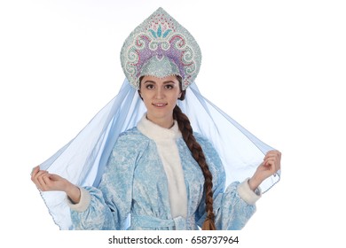 Portrait of a fairy-tale Snow Maiden in a blue suit and kokoshnik with a veil on a white background studio