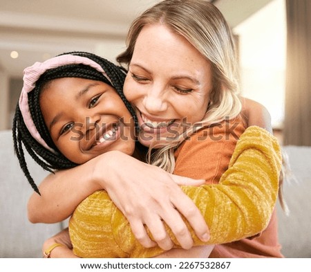 Portrait, family and adoption with a girl and mother hugging in a living room of their house together. Face, love and children with a foster parent woman and daughter embracing while bonding at home