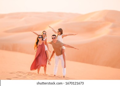 Portrait of family in big sand desert on summer vacation