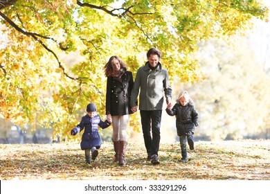 Portrait of family with children walking in autumn park