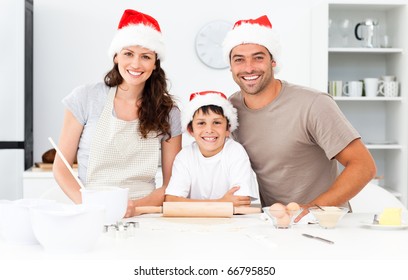 Portrait Of A Family Cooking Christmas Cookies In The Kitchen