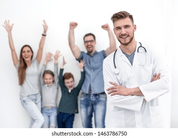 Portrait Of A Family Doctor On The Background Of His Happy Patients