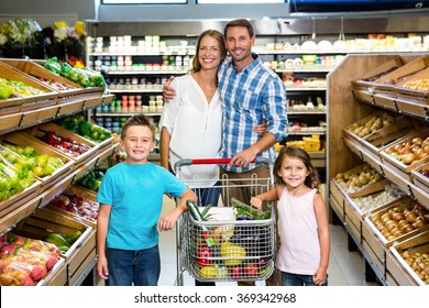 Portrait Of Family Doing Shopping In Grocery Store