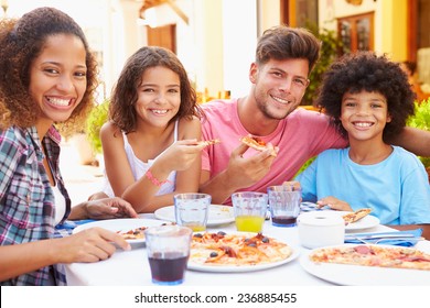 Portrait Of Family Eating Meal At Outdoor Restaurant