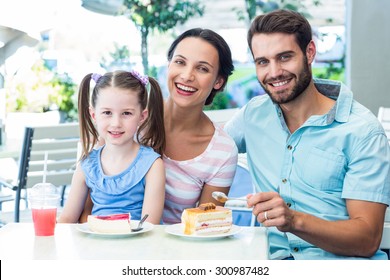 Portrait Of A Family Eating At The Restaurant On A Sunny Day