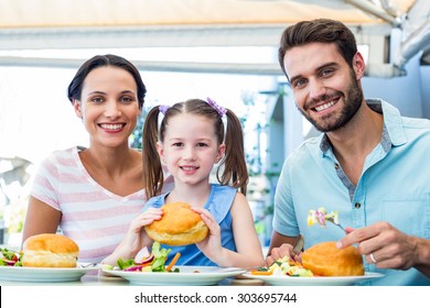 Portrait Of A Family Eating At The Restaurant On A Sunny Day